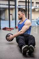 Muscular man training with exercise ball