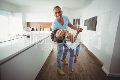 Happy couple dancing in the kitchen