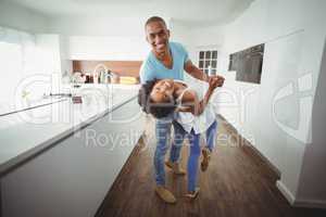 Happy couple dancing in the kitchen