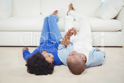 Smiling couple lying on the floor