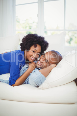 happy couple lying on the sofa