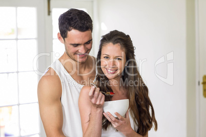 Young couple having breakfast in kitchen