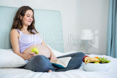 Pregnant woman reading a book