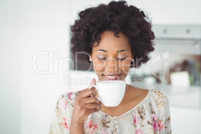 Peaceful woman holding white mug