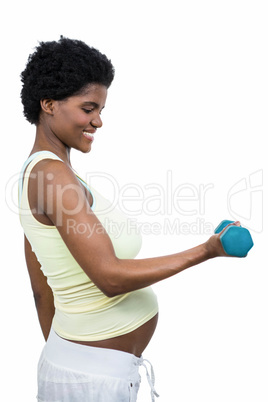 Pregnant woman lifting dumbbell