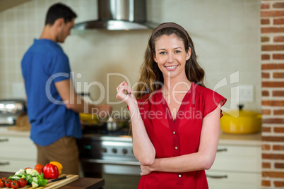 Portrait of young woman smiling in kitchen