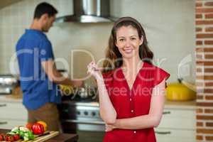 Portrait of young woman smiling in kitchen