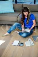 business woman sitting on the floor writing