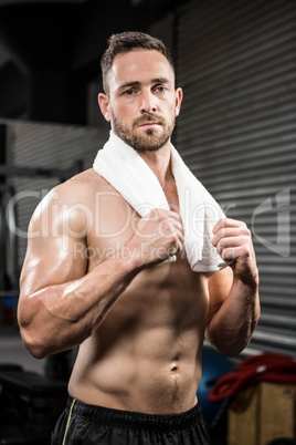 Portrait of shirtless man with towel around neck