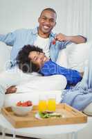 Handsome man feeding his girlfriend with strawberry