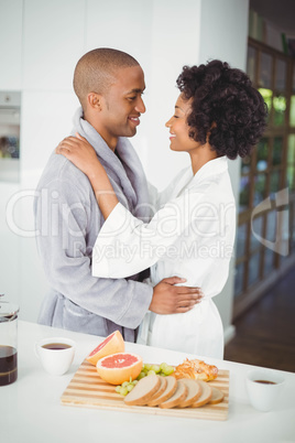 Happy couple hugging in the kitchen