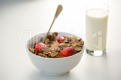 View of a bowl of cereals and glass of milk