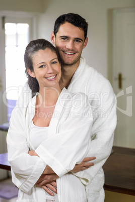 Couple in bathrobe embracing each other