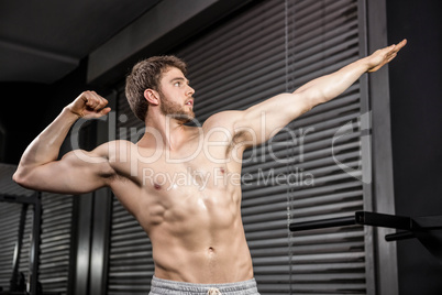 Shirtless man flexing muscles