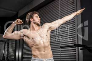 Shirtless man flexing muscles