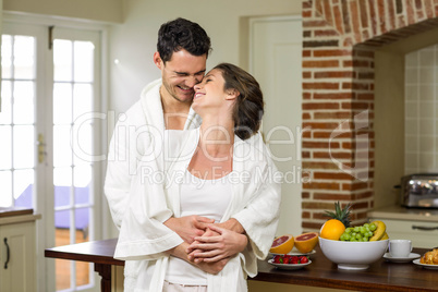 Couple in bathrobe embracing each other