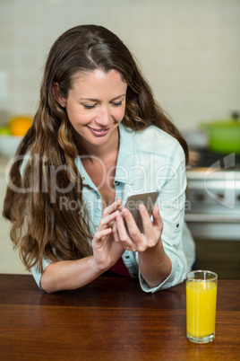 Young woman text messaging on mobile phone