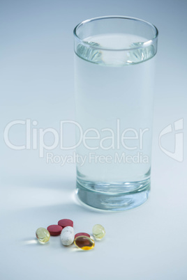 Pills beside glass of water