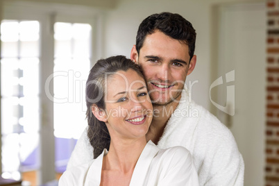 Couple in bathrobe embracing each other