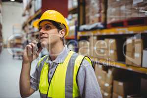 Warehouse worker on a phone call