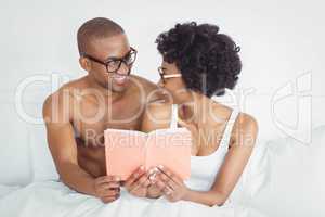 happy couple reading a book together