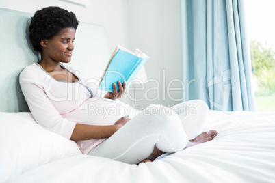 Pregnant woman reading a book