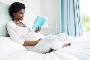 Pregnant woman reading a book