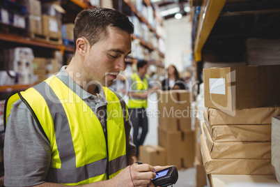 Warehouse worker scanning box