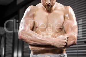 Shirtless man flexing biceps