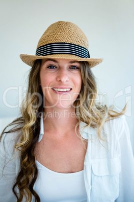 brunette woman wearing a woven straw hat