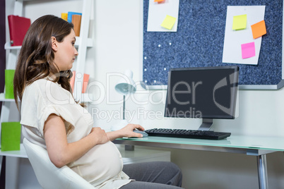 Pregnant woman using computer