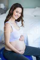 Pregnant woman sitting on exercise ball