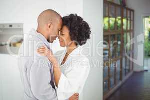 Happy couple hugging in the kitchen