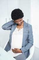 Pregnant businesswoman with neck pain