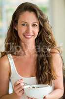 Portrait of beautiful brunette woman having breakfast