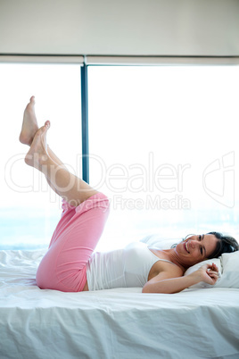 smiling woman with her feet in the air