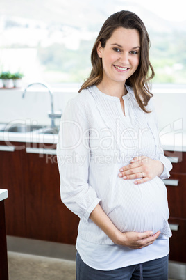 Pregnant woman touching her belly