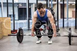 Muscular man lifting barbell