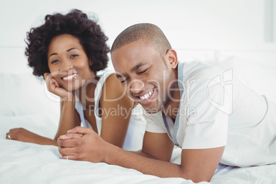 Happy couple lying on the bed