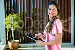 smiling woman scrolling on her tablet