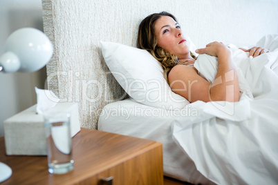 sick woman lying in her bed