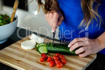 woman preparing sliced vegetbles