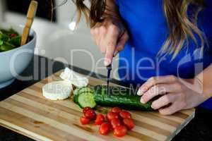 woman preparing sliced vegetbles