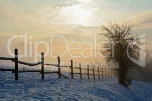 Zaun im Winter beim Sonnenaufgang