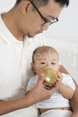 Father bottle feed baby
