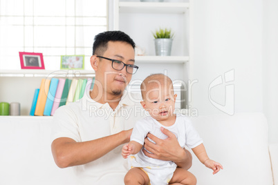 Father burping baby after meal