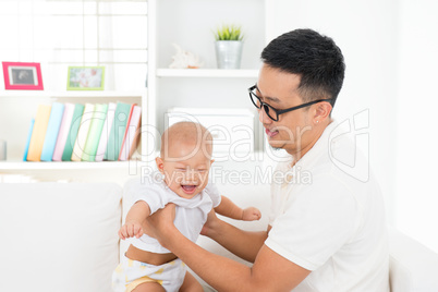 Father and baby boy playing