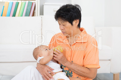 Nanny bottle feeding baby
