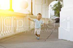 Asian toddler running at outdoor