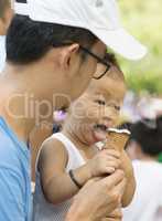 Father and child eating ice creams